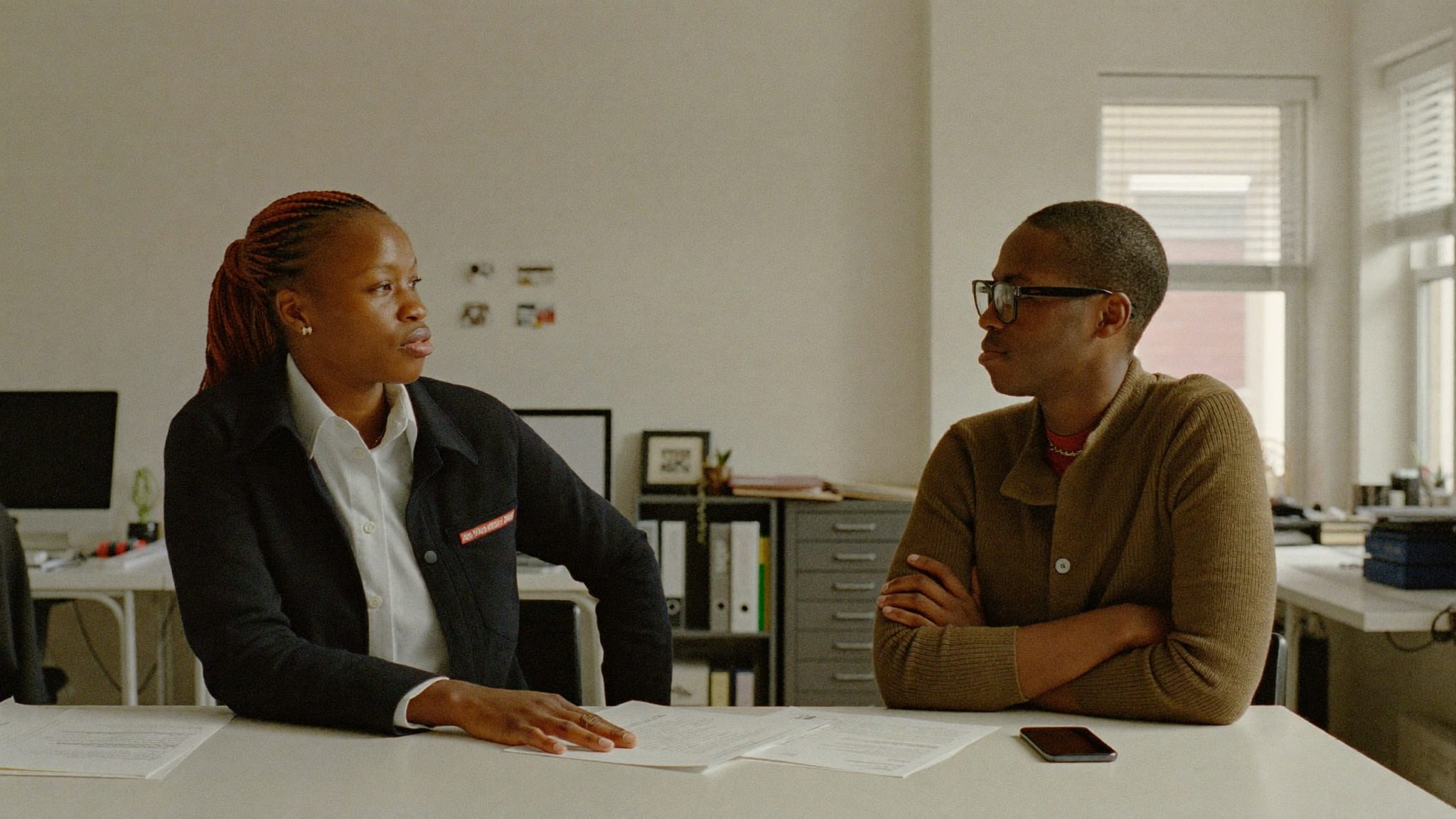 Two advisers in conversation in a meeting room